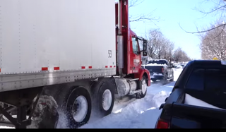 Illustration for article titled 'Ford Tough' Watch an F-150 Pull a Semi From Snowy Despair